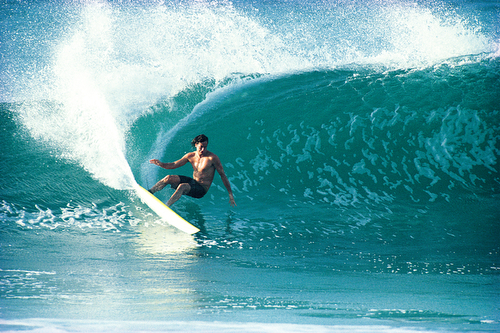 One of the most vivid memories from the '80s and '90s is Tom Curren laying down a huge frontside cutback at Backdoor on a logo-less reverse vee shaped by Maurice Cole. Curren made a bold statement riding that board while taking a shot at the world title, something many core surfers respected. Photo: Tom Servais